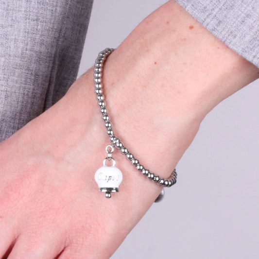 AMO CAPRI - BRACCIALE IN ACCIAIO CON CAMPANELLA PICCOLA BIANCA SCRITTA CAPRI