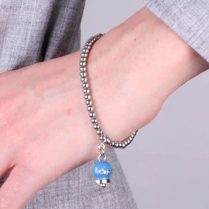 AMO CAPRI - BRACCIALE IN ACCIAIO CON CAMPANELLA AVIO PICCOLA SCRITTA CAPRI