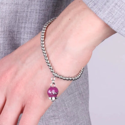 AMO CAPRI - BRACCIALE IN ACCIAIO CON CAMPANELLA SMALTO BORGOGNA E SCRITTA CAPRI