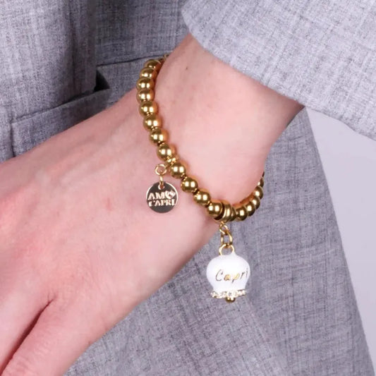 AMO CAPRI - BRACCIALE IN ACCIAIO DORATO CAMPANELLA BIANCA E CRISTALLI