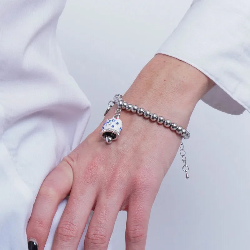 AMO CAPRI - BRACCIALE IN ACCIAIO CON CAMPANELLA BIANCA E POIS BLU