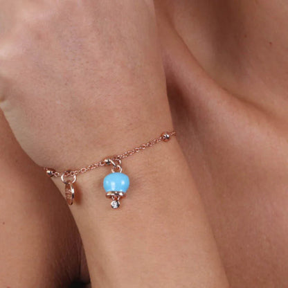 AMO CAPRI - BRACCIALE IN METALLO ROSE' CON CAMPANELLA MINI TURCHESE E PUNTO LUCE