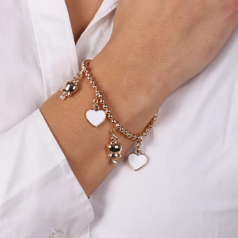 AMO CAPRI - BRACCIALE IN METALLO DORATO CON CAMPANELLE E CUORI BIANCHI
