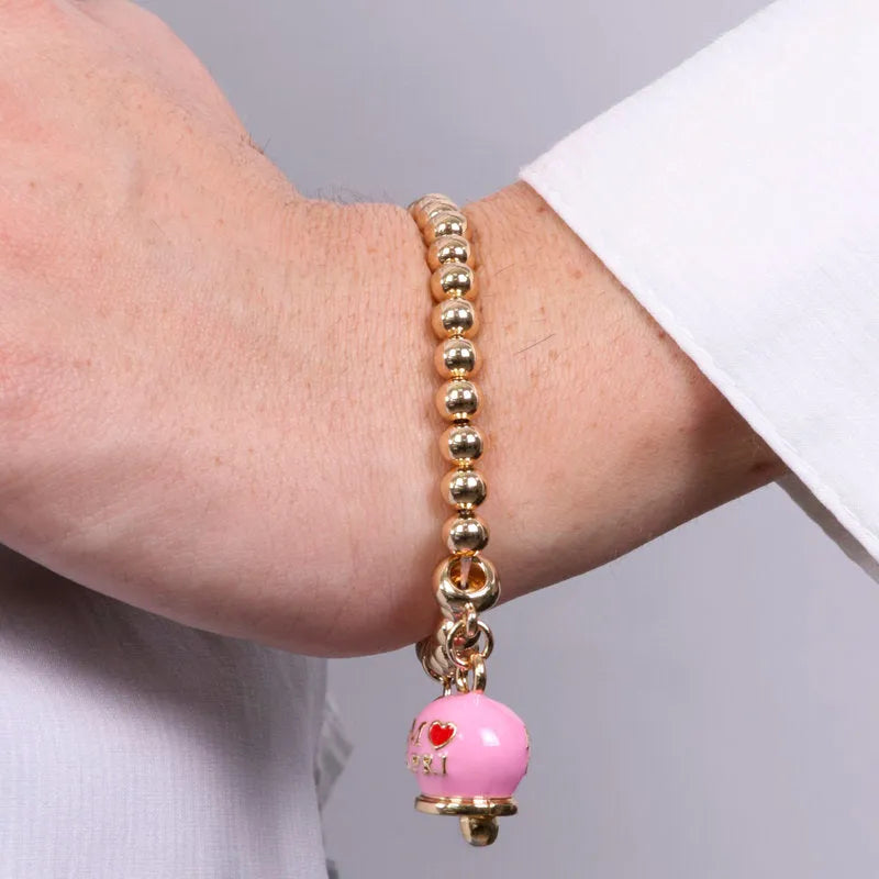 AMO CAPRI - BRACCIALE IN METALLO DORATO CON CAMPANELLA ROSA SCRITTA AMO CAPRI