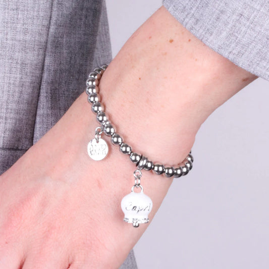 AMO CAPRI - BRACCIALE IN ACCIAIO CON CAMPANELLA BIANCA SCRITTA CAPRI E CRISTALLI